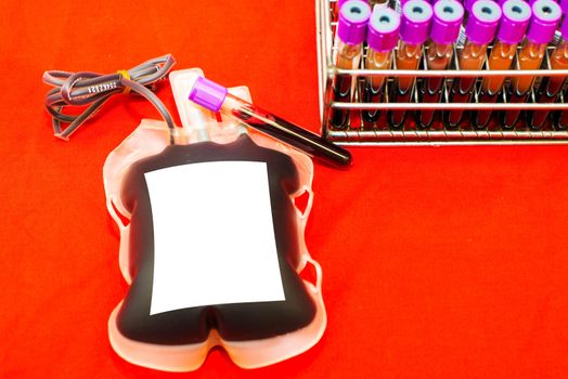 Close up bag of blood and plasma and rubber tube isolated on Red background