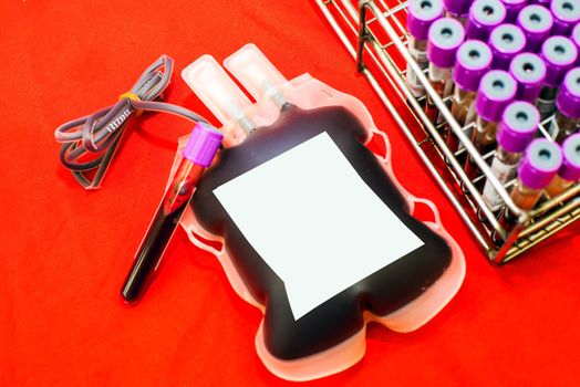 Close up bag of blood and plasma and rubber tube isolated on Red background