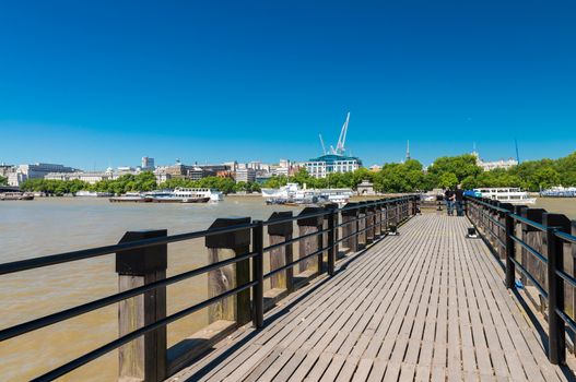 London. Jetty over Thames river on a beautiful day.