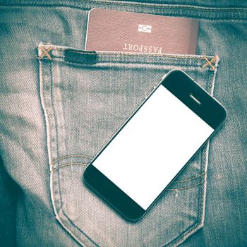 passport in jean pocket with smart phone retro vintage style