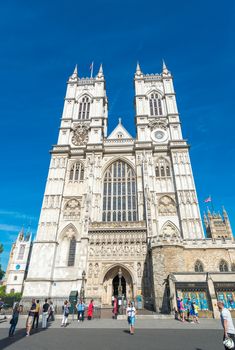 LONDON - JUNE 14, 2015: Tourists near Westminster Abbey. London is visited by 50 million people annually.