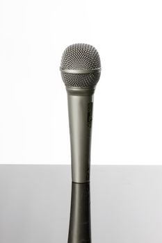 Microphone on a white background with reflection