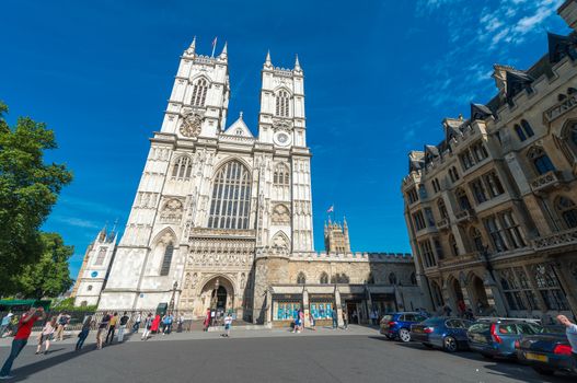LONDON - JUNE 14, 2015: Tourists near Westminster Abbey. London is visited by 50 million people annually.