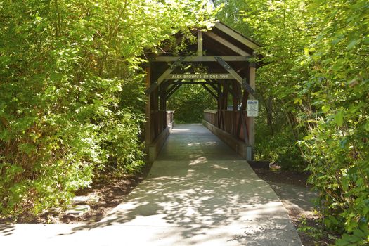 Small wooden covered bridge in Fairview Village Oregon.