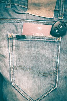 passport in jean pocket with car key retro vintage style