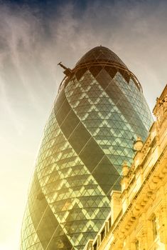 LONDON - JUNE 13: View of Gherkin building (30 St Mary Axe) at sunset in London on June 13, 2015. Gherkin - iconic symbol of London, one of city's most widely recognized examples of modern architecture