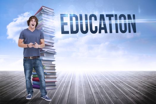 The word education and open-mouthed student holding a cellphone against stack of books against sky