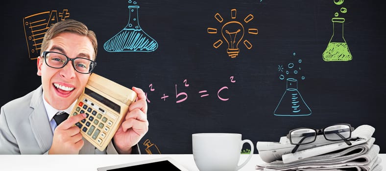 Geeky smiling businessman showing calculator against blackboard