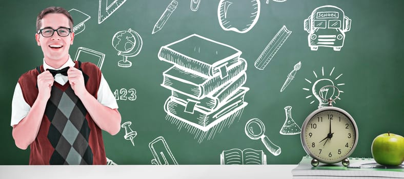 Geeky hipster fixing his bow tie against green chalkboard