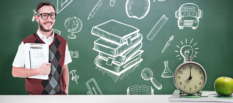 Geeky man holding clipboard in vest against green chalkboard