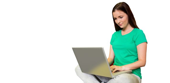 Student sitting on floor in library using laptop  against white background with vignette