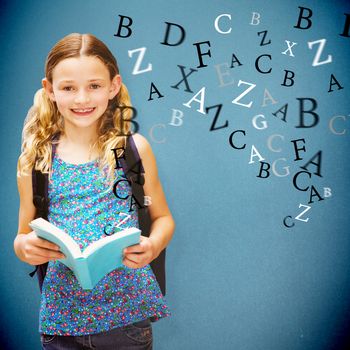 Cute little girl reading book in library against blue background