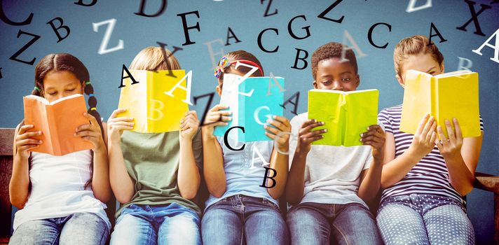 Children reading books at park against blue background