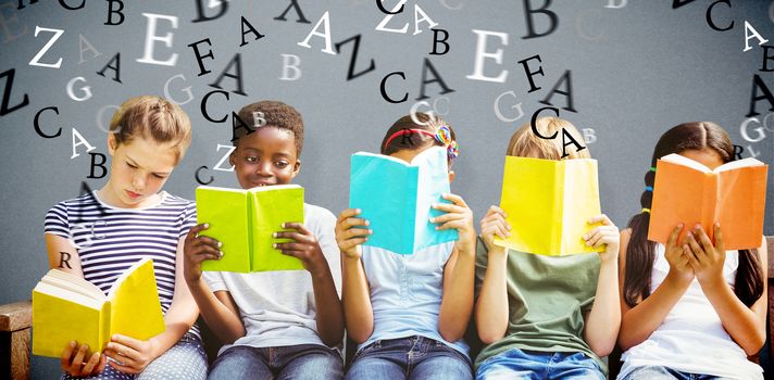 Children reading books at park against grey background