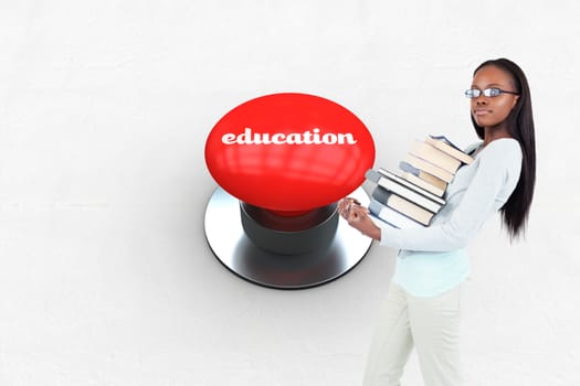 The word education and side view of young woman carrying a pile of books against digitally generated red push button