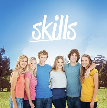 The word skills and a group of friends smiling and holding each other against walkway along lined trees in the park