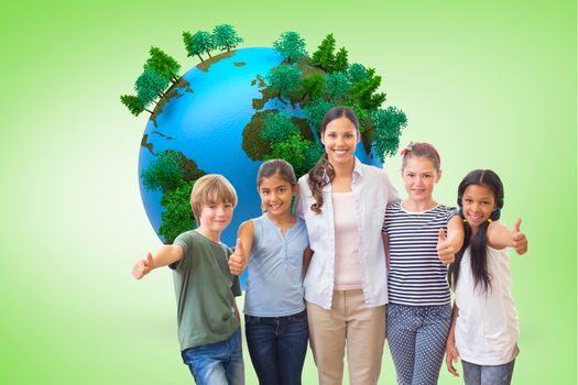 Cute pupils and teacher smiling at camera in computer class  against green vignette