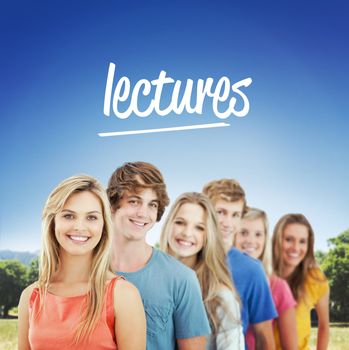 The word lectures and a group standing behind one another at an angle against students using laptop in lawn against college building