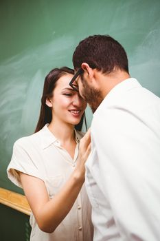 Side view of businessman and woman looking at each other in office