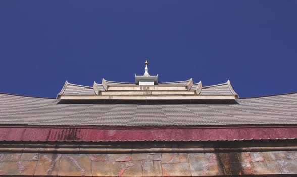 Pinnacle has a tile roof with blue sky.