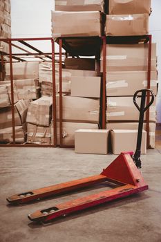 Storage cart on floor with boxes behind in warehouse 