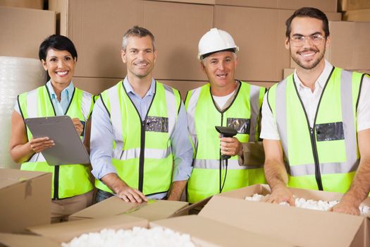 Portrait of smiling team standing in warehouse