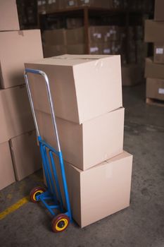 Cardboard boxes on trolley in warehouse