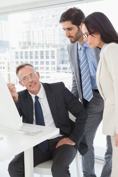 Business people looking at a computer in the office