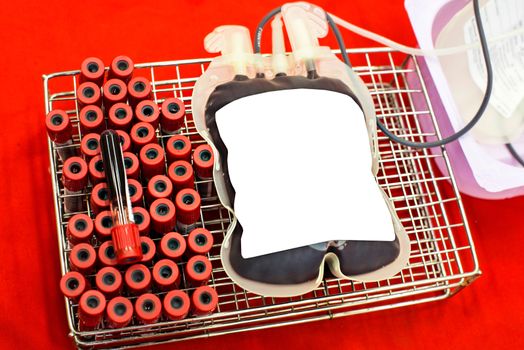 Close up bag of blood and plasma and rubber tube isolated on Red background