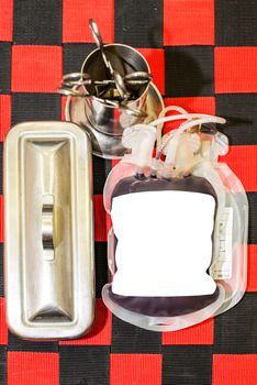 Close up bag of blood and plasma and rubber tube isolated on Red background