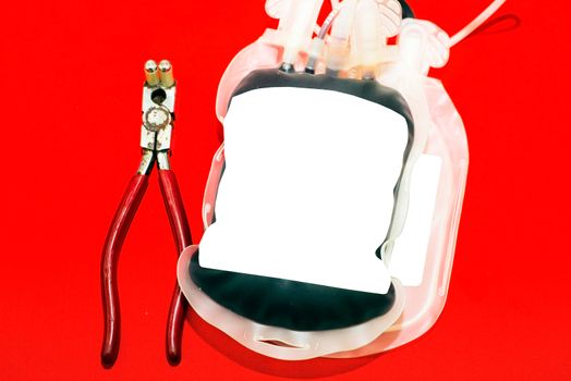 Close up bag of blood and plasma and rubber tube isolated on Red background