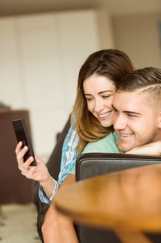 Cute couple taking a selfie at home in the living room