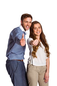 Portrait of happy young couple gesturing thumbs up over white background