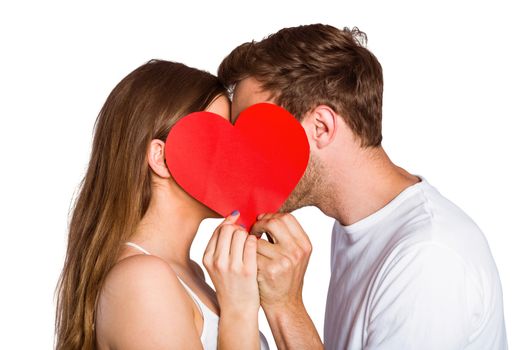 Close up side view of romantic couple holding heart over white background