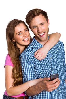 Portrait of cheerful young couple with mobile phone over white background