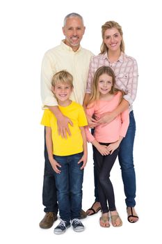 Happy family smiling at camera on white background