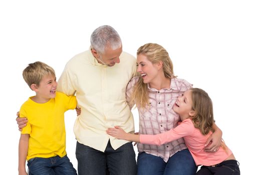 Happy family smiling at each other on white background