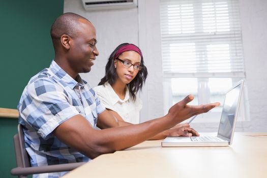 Business people working on a laptop and a tablet in the office