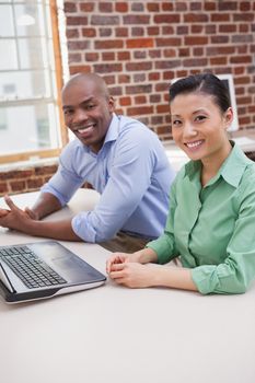 Casual business team working together at desk in the office