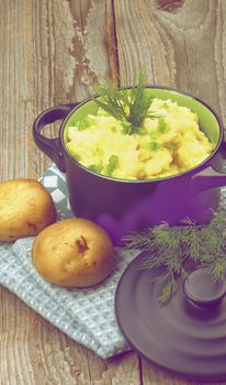 Homemade Mashed Potato with Dill and Spring Onion in Dark Blue Casserole with Lid on Rustic Wooden background. Retro Styled