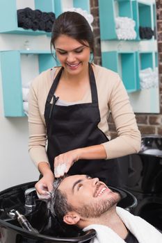 Hair stylist washing mans hair at the hair salon