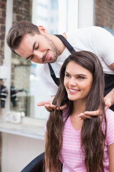 Handsome hair stylist with client at the hair salon