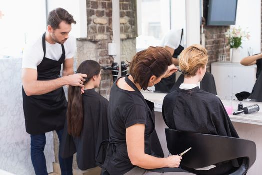 Hairdressers working on their clients at the hair salon