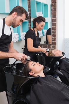 Hairdressers washing their clients hair at the hair salon