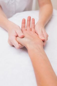 Woman getting a hand massage at the beauty salon