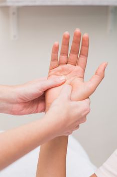 Woman getting a hand massage at the beauty salon