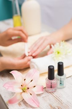 Nail technician giving customer a manicure at the beauty salon