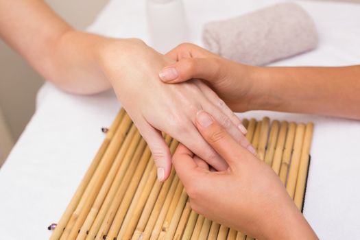 Woman getting a hand massage at the beauty salon