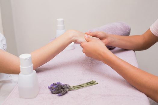 Woman getting a hand massage at the beauty salon