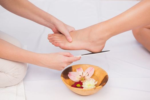 Woman getting a pedicure from beautician at the beauty salon